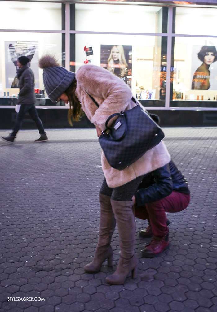 women's winter fashion what to wear street style how to wear pink faux fur coat grey beanie with fur pom pom and grey over the knee designer boots